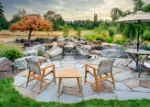 Waterfall and pond bordering flagstone patio