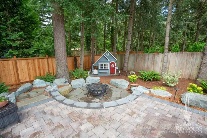 Paver patio with boulder-seat fire feature.