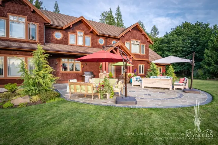 stunning, circular, multi-room flagstone patio with paver border and insets