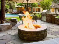 Gas fire pit centered on random flagstone patio.