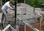 pouring concrete into concrete forms